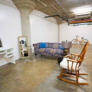 Studio corner dressed with a console, sofa and rocking chair