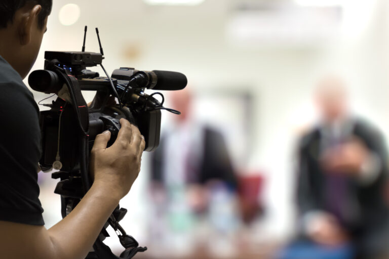 Camera operator filming a customer interview